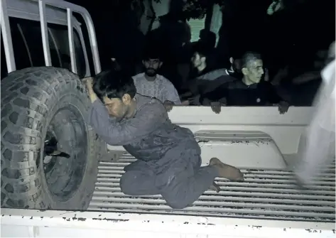  ?? HAMED SARFARAZI/THE ASSOCIATED PRESS ?? A wounded man rests on a vehicle after a suicide attack on a mosque in Herat, Afghanista­n, Tuesday. An Afghan hospital official says an explosion inside a minority Shiite mosque in western Herat, on the border with Iran, has killed 29 people.