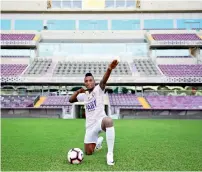  ?? — Al Ain Twitter ?? Kodjo Fo-Doh Laba does Usain Bolt’s trademark sign after his unveiling at the Hazza bin Zayed Stadium.