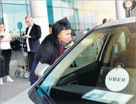  ?? Wally Skalij Los Angeles Times ?? A DEAL is still in the works, a SoftBank executive said. The long-anticipate­d investment by the Japanese firm would give it stakes in the biggest ride-hailing players across Asia and the West. Above, an Uber customer at LAX in June.