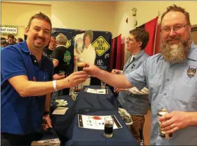  ?? FILE PHOTO ?? Artisanal Brew Works owner and brewer Colin Quinn, right, serves a customer at the 2018 Saratoga Beer Summit.