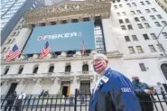  ?? AP PHOTO/ MARK LENNIHAN ?? Stock trader Thomas Ferrigno arrives to work Monday at the New York Stock Exchange.