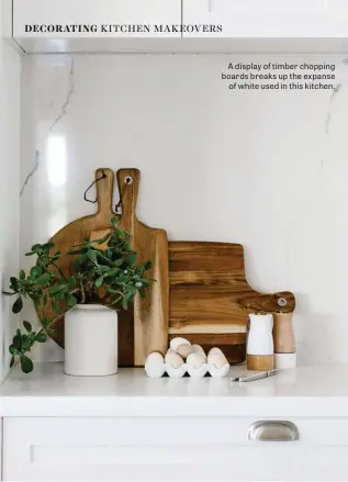  ??  ?? A display of timber chopping boards breaks up the expanse of white used in this kitchen.