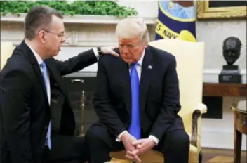  ?? JACQUELYN MARTIN — THE ASSOCIATED PRESS ?? President Donald Trump prays with American pastor Andrew Brunson in the Oval Office of the White House, Saturday in Washington. Brunson returned to the U.S. around midday after he was freed Friday, from nearly two years of detention in Turkey.