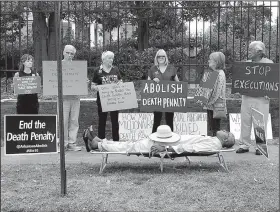  ?? SHERRY SIMON via AP ?? Pulaski County Circuit Judge Wendell Griffen, shown protesting at the Governor’s Mansion on Friday, said on his blog that he was portraying a crucified Jesus and that his hat covered “a black leather bound King James Version of the Bible, the book that...