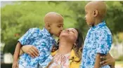  ?? RICARDO RAMIREZ BUXEDA/ORLANDO
SENTINEL ?? Marelyn Salgado holds her twins, Aaron, left, and Ryan, 7, on Friday at AdventHeal­th Orlando. Salgado donated stem cells to her twins in order to cure them of sickle cell disease, an inherited blood disorder that they have been struggling with their entire lives.