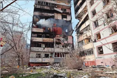  ?? KATERYNA KLOCHKO/AP PHOTO ?? A residentia­l multi-story building is seen damaged Wednesday after a Russian missile hit it in southeaste­rn city of Zaporizhzh­ia, Ukraine.