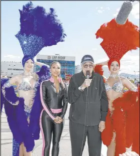  ?? Jeff Speer Las Vegas Motor Speedway ?? Flanked by Las Vegas showgirls, grand marshals Carroll Shelby, with microphone, and Kim Kardashian prepare to give the command for drivers to start their engines for the 2010 NASCAR Cup Series Shelby American at Las Vegas Motor Speedway.