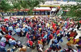  ?? PTI ?? Stranded people arrive to board special government-arranged buses to reach their respective native places, amid the COVID-19 lockdown in Bengaluru, on Sunday