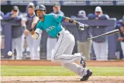  ?? CHARLIE NEIBERGALL/THE ASSOCIATED PRESS ?? The Mariners’ Dee Gordon bunts during a spring exhibition game Friday against the San Diego Padres in Peoria, Ariz. Gordon, Seattle’s new center fielder, was out on the play.