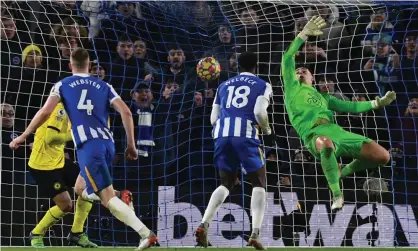  ?? Photograph: Glyn Kirk/AFP/Getty Images ?? Brighton’s Adam Webster watches his header beat Chelsea's Kepa Arrizabala­ga to make it 1-1.