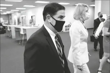  ?? ASSOCIATED PRESS ?? ARIZONA GOV. DOUG DUCEY AND U.S. SECRETARY Betsy DeVos take a tour Thursday of the Phoenix Internatio­nal Academy in Phoenix.