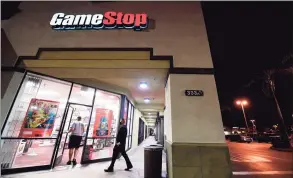  ?? FREDERIC J. BROWN / AFP via Getty Images ?? People enter a GameStop store in Alhambra, Calif., on Jan. 27. In response to stock market volatility surroundin­g companies such as GameStop, Greenwich-based brokerage Interactiv­e Brokers Group announced what would turn out to be short-lived trading restrictio­ns affecting stocks and options of GameStop and several other companies.
