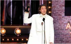  ?? ?? American actor and singer Aaron Tveit accepts the award for Best Performanc­e by an Actor in a Leading Role in a Musical for “Moulin Rougeî.