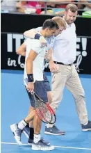  ??  ?? Gregor Dimitrov sportingly helps an injured Kyle Edmund to his chair
