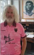  ??  ?? Mick Wallace wearing the new jersey in his office, with a portrait of Che Guevara in the background.