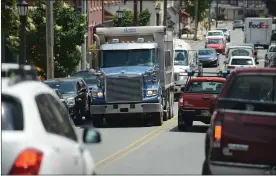  ?? MEDIANEWS GROUP FILE PHOTO ?? A truck hauls incinerato­r waste as it squeezes through Boyertown traffic on its way to the Rolling Hills Landfill in Earl Township. The landfill’s expansion was approved despite concerns expressed by borough officials.