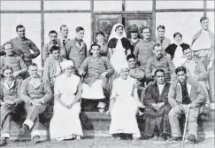  ??  ?? A group of New Zealanders in WaltononTh­ames Hospital, England. Private C. Somerville is seated in the centre, between the nurses. — Otago Witness, 25.7.1917.