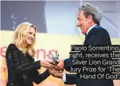  ??  ?? Paolo Sorrentino, right, receives the Silver Lion Grand Jury Prize for ‘The Hand Of God’.