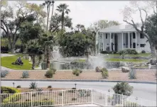  ??  ?? Las Vegas Review-journal file A worker cuts grass in 2013 at the former estate of entertaine­r Wayne Newton. Casa de Shenandoah, at the corner of Sunset and Pecos roads, has closed to the public as an attraction.