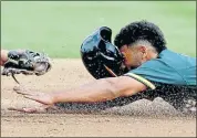  ?? CHRIS CARLSON – THE ASSOCIATED PRESS ?? The A’s Marcus Semien is tagged outwhile trying to steal during Thursday’s game against the Angels