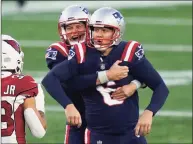  ?? Elise Amendola / Associated Press ?? Patriots kicker Nick Folk, front, celebrates his 50-yard winning field goal against the Arizona Cardinals with holder Jake Bailey as time expires on Sunday.