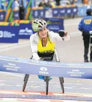  ?? AP ?? McFadden celebrates as she wins the women’s wheelchair division of the New York City marathon in 2015. McFadden set a new course record with 1:35:06 in the event.