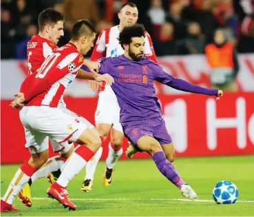  ?? Photo: AFP ?? Liverpool’s forward Mohamed Salah (R) kicks the ball during the UEFA Champions League Group C second-leg match against Red Star Belgrade at the Rajko Mitic Stadium in Belgrade yesterday