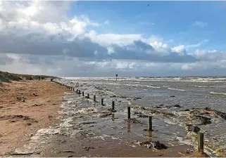  ?? ?? ● High tide flooding the closed beach car park at Ainsdale