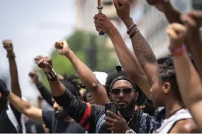  ??  ?? On a hot, humid day in Washington, throngs of protesters gathered at the Capitol, on the National Mall and in residentia­l neighborho­ods. Many groups headed toward the White House, where President Donald Trump was.