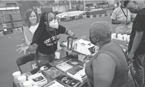  ?? NICOLAS GALINDO/COLUMBUS DISPATCH ?? Alona Davidson, a recruiter for Kentucky State University, speaks to Tina Johnson during the 2021 Battelle College, Career & Community Fair at Ohio State University Saturday. “I’m just trying to get some informatio­n for my daughter,” Johnson said. “She’s in the ninth grade and we need to start thinking about college."