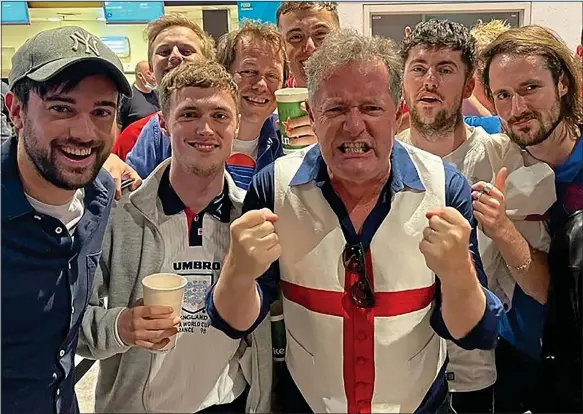  ??  ?? COME ON, ENGLAND! Piers, sporting his St George’s flag waistcoat, at Wembley with fans including his sons and comedian Jack Whitehall, far left