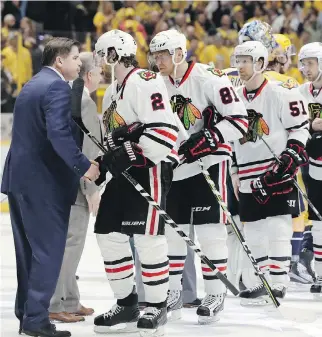  ?? THE ASSOCIATED PRESS ?? Nashville coach Peter Laviolette shakes hands with Blackhawks defenceman Duncan Keith after the Predators completed the sweep. Keith, the Conn Smythe winner in 2015, struggled in the series.