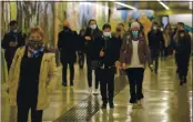  ?? LUCA BRUNO — THE ASSOCIATED PRESS ?? People wear masks to prevent the spread of COVID-19 as they walk in the undergroun­d of the Garibaldi railway station, in Milan, Italy, Tuesday. Italian Premiere Giuseppe Conte ordered strict new anti-COVID measures early Tuesday, including limits on private gatherings and a ban on casual pickup sports.