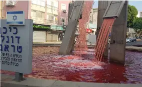  ?? (Alon Hachmon) ?? THE WATER of the fountain at Donald Trump Square in Petah Tikva was colored red yesterday in protest against annexation.