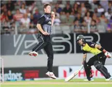  ?? AFP ?? New Zealand’s Ben Wheeler fields off his own bowling as Australia’s Glenn Maxwell (right) looks on.