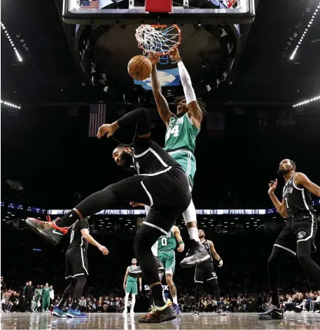  ?? Getty imAgeS ?? HE’S BACK: Robert Williams dunks against Brooklyn’s Andre Drummond during Game 3 of the Celtics’ Eastern Conference first-round playoff series with the Nets on Saturday night at the Barclays Center.