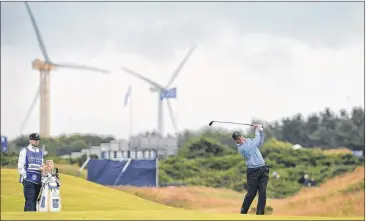 ?? MARK RUNNACLES / AP ?? Matt Kuchar battled through wind and rain Saturday at the Scottish Open to post a 1-over 73. “I was out there thinking what my friends back home would be doing,” said Kuchar, who is tied for eighth, four shots back.