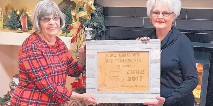  ??  ?? Carolyn Chance, right, accepts the 2017 CowBelle of the Year award from Lyn Greene, Chuckwagon CowBelles.