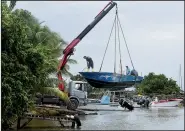  ?? AP/DOMINIQUE CHOMEREAU-LAMOTTE ?? Men remove boats from the water ahead of Hurricane Maria in the Galbas area of Ste.-Anne on the French Caribbean island of Guadeloupe early Monday.