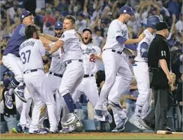  ??  ?? PENNANT FEVER like this town hasn’t seen in 29 years surged through Dodger Stadium as the Dodgers moved within two wins of a World Series return.