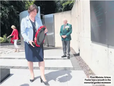  ?? PACEMAKER ?? First Minister Arlene Foster lays a wreath in the memorial garden