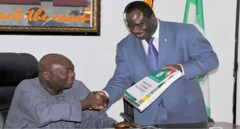  ??  ?? DirectorGe­neral of NAFDAC Dr. Paul Orhii presenting enlightenm­ent materials to the DirectorGe­neral of NTA Mr. Sola Omole when the later paid a courtesy visit to NTA, recently.