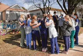  ?? Jay Janner / Austin American-Statesman via AP ?? Doctors and nurses from Pediatrics Associates of Austin gather at a memorial to pay their respects to Dr. Katherine Lindley Dodson outside Children’s Medical Group on Wednesday.