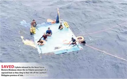  ?? CONTRIBUTE­D PHOTO ?? SAVED
A photo released by the Naval Forces Western Mindanao shows the six Filipino passengers of a capsized boat as they cling to their life off the southern Philippine province of Sulu.