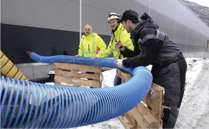  ?? TOR INGE JØSSANG ?? Fisken skimes i slangen, som Timothy Lee Laugaland har koplet på inntaket i laksefabri­kken, som Roger og Nils Viga står bak.