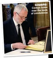  ??  ?? SOMBRE: Corbyn looks over the book of condolence