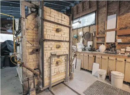  ??  ?? A 20-cubic-foot gas kiln in the garage, next to the studio, is used for high-temperatur­e firing of stoneware.