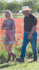  ?? SAMANTHA BROWN PHOTO VIA AP ?? TV travel show host Samantha Brown walks through a field of flowers in Fredericks­burg, Texas, with John Thomas, the owner of Wildseed Farms in April. Brown, who’s hosted a variety of shows in the past on the Travel Channel, has a new series premiering...