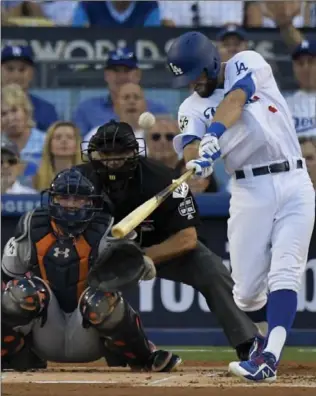 ?? MARK J. TERRILL, THE ASSOCIATED PRESS ?? Dodgers’ Chris Taylor hits a home run against the Houston Astros to lead off Game 1 of the World Series on Tuesday night in Los Angeles. Starting pitcher Clayton Kershaw and the bullpen were outstandin­g for L.A.