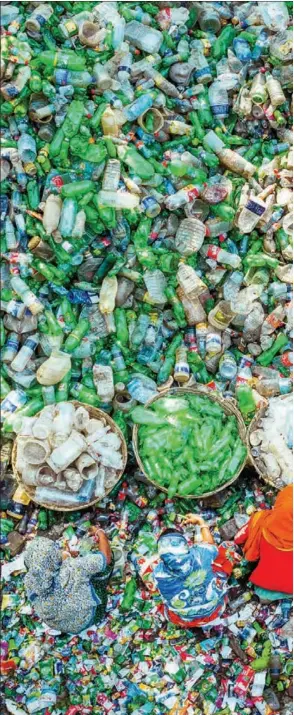  ?? RATUL DHAR / SOLENT NEWS ?? Workers sort tens of thousands of plastic bottles in Brahmanbar­ia district, e